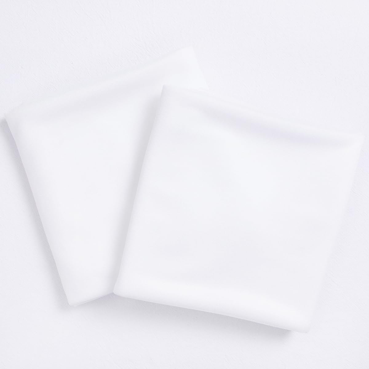 Socomi white sheer arch draping fabric panel hanging in daylight for airy wedding photos.