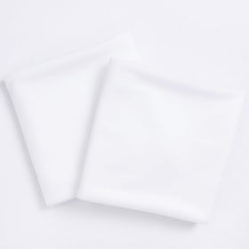Socomi white sheer arch draping fabric panel hanging in daylight for airy wedding photos.