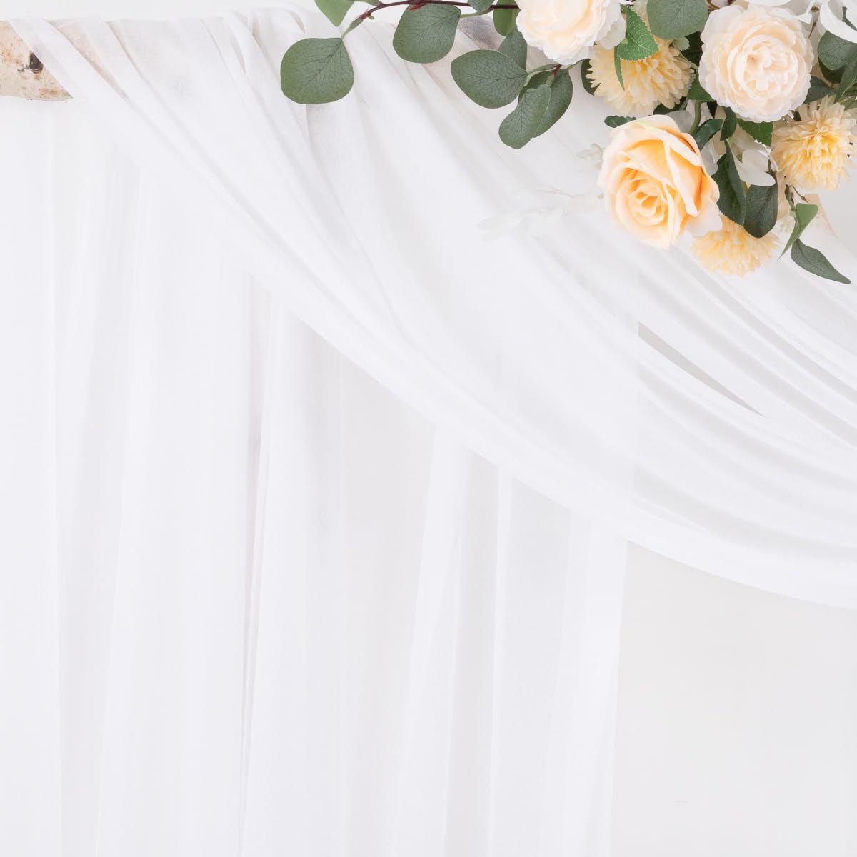 Socomi white sheer arch draping fabric panel rolled to create soft backdrop swags.