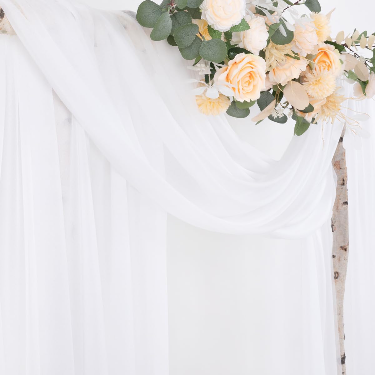 Socomi white sheer arch draping fabric panel closeup texture enhances wedding decor lighting.