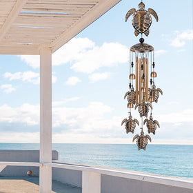 Solawindchime bronze sea turtle wind chime on patio delivers calming outdoor ambiance.