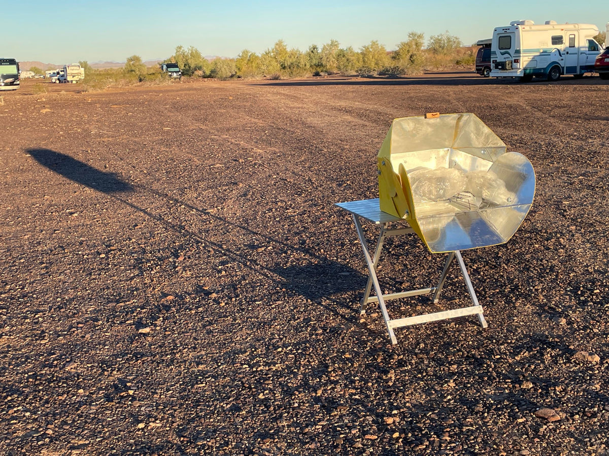 SolCook solar cooker in camping setup harnesses sun for off-grid meals.