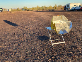 SolCook solar cooker in camping setup harnesses sun for off-grid meals.