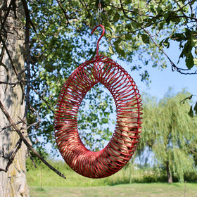 Bright red Songbird Essentials wreath feeder boosts visibility for wildlife