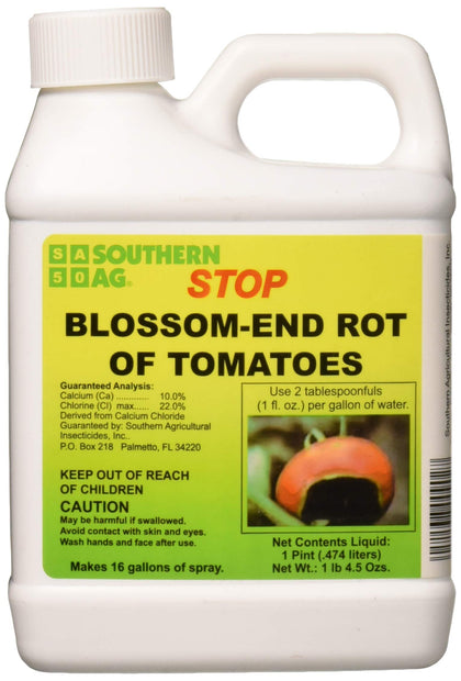 Southern Ag Stop Blossom-End Rot bottle beside tomato plant for calcium support.