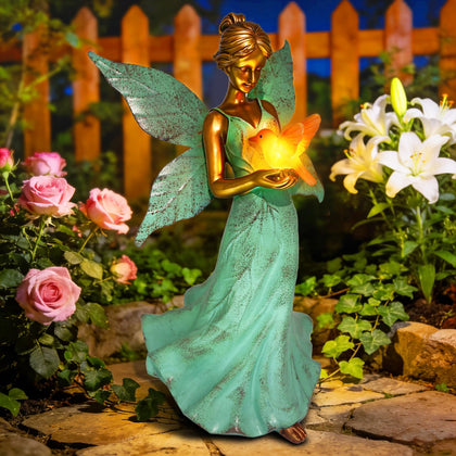 Stadeco Solar Angel hummingbird statue glowing softly at dusk for yard ambience