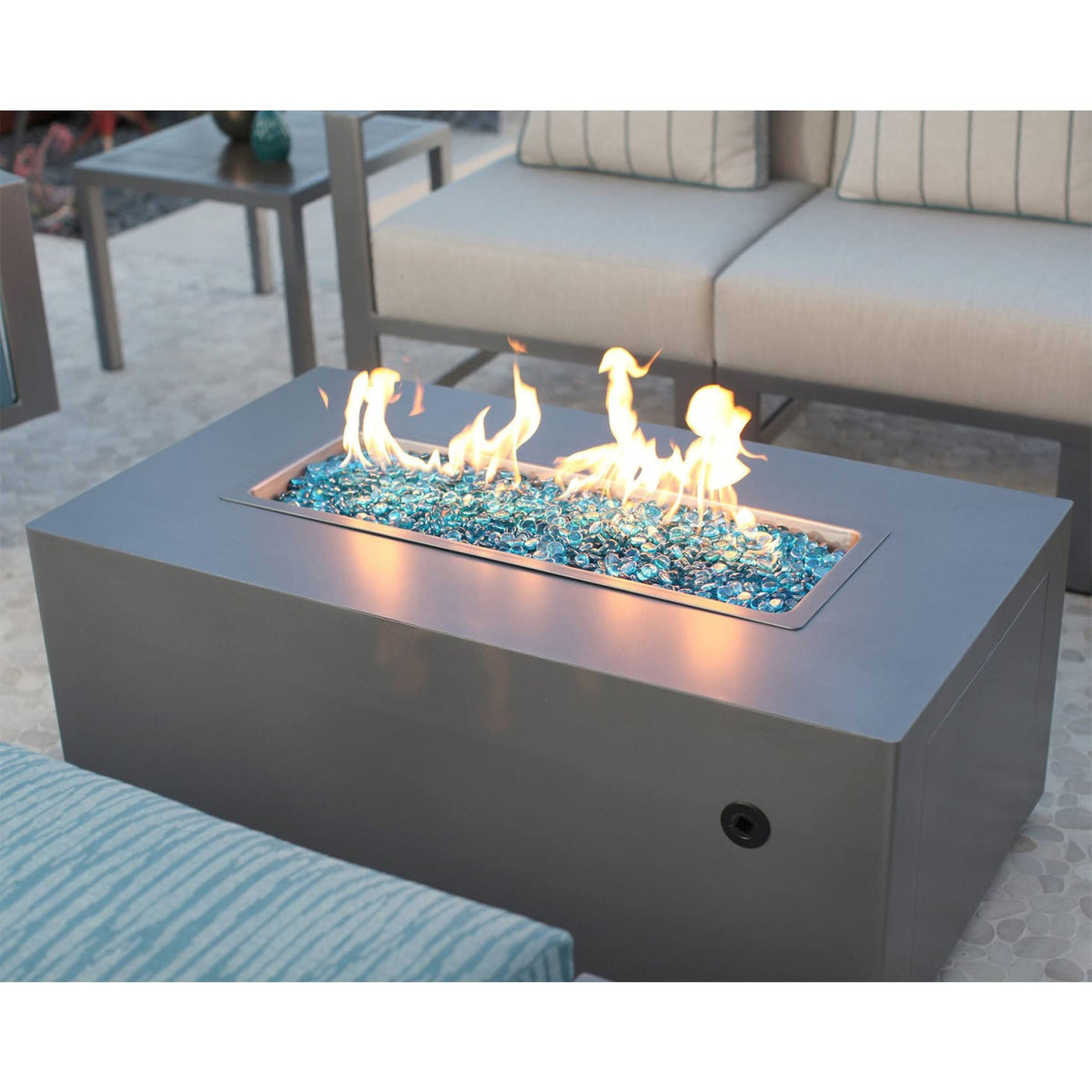 Decorative use of Stanbroil Caribbean Blue Luster fire glass drops in landscaping