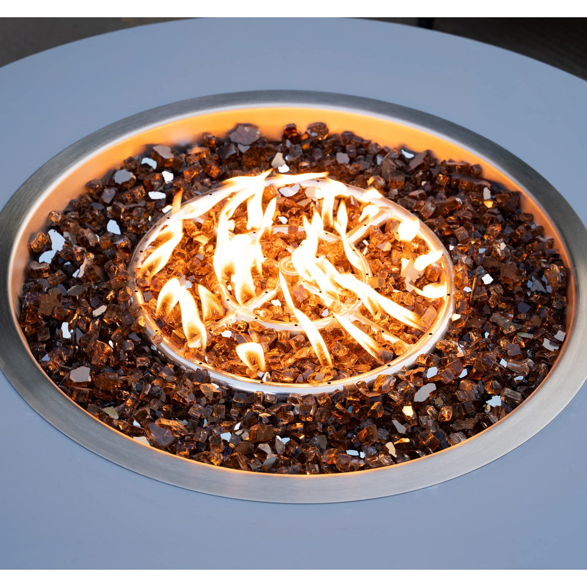 Close-up of Stanbroil copper reflective fire glass showing jewel-like color