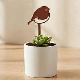 Silhouette bird stake elevates plant displays with whimsy.
