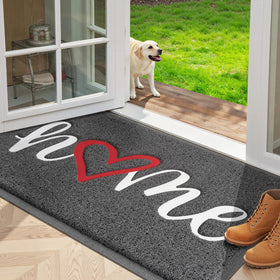 StepLively door mat with embossed home pattern traps dirt at the doorstep.