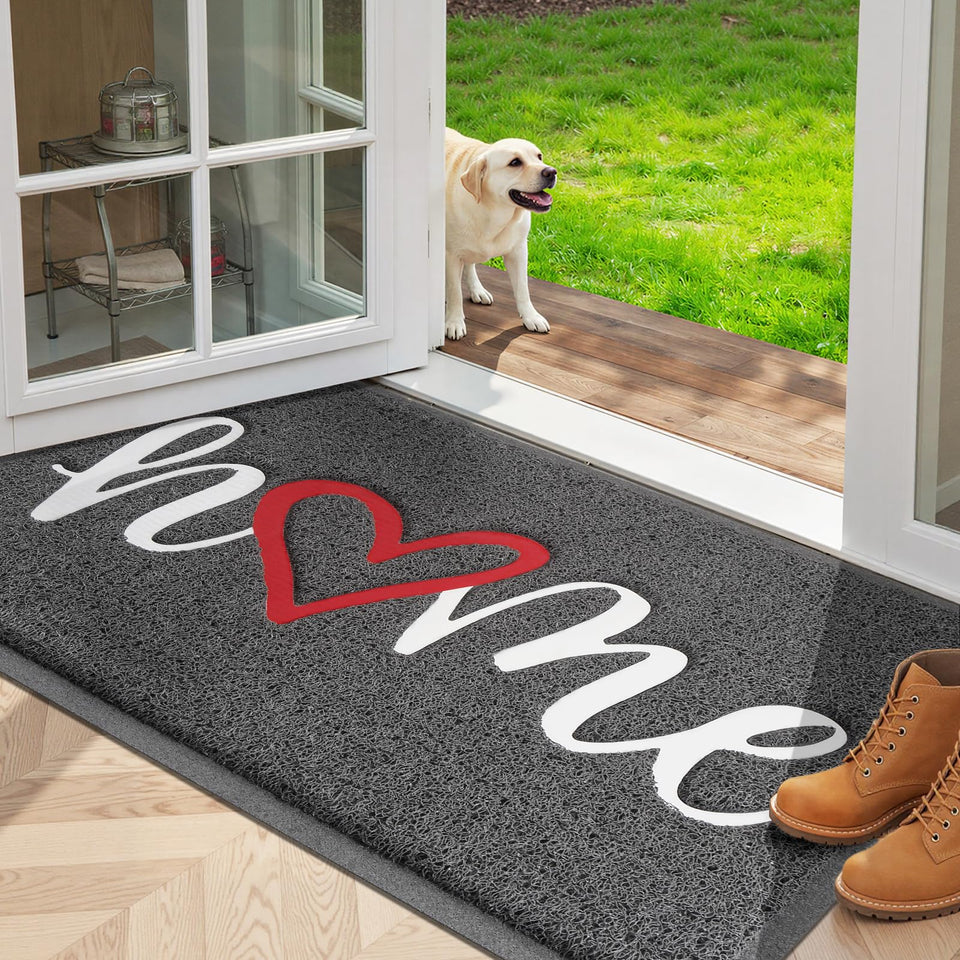 StepLively door mat with embossed home pattern traps dirt at the doorstep.