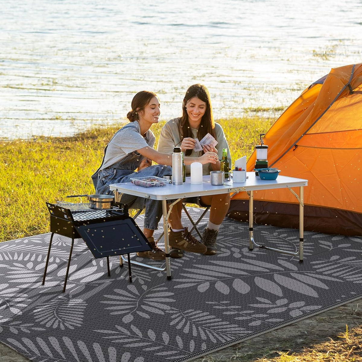 Beach picnic setup featuring StepRite rug for seating and sand-free space.