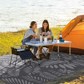 Beach picnic setup featuring StepRite rug for seating and sand-free space.