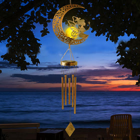 Sunlight reflecting off STF ShangTianFeng wind chime in garden
