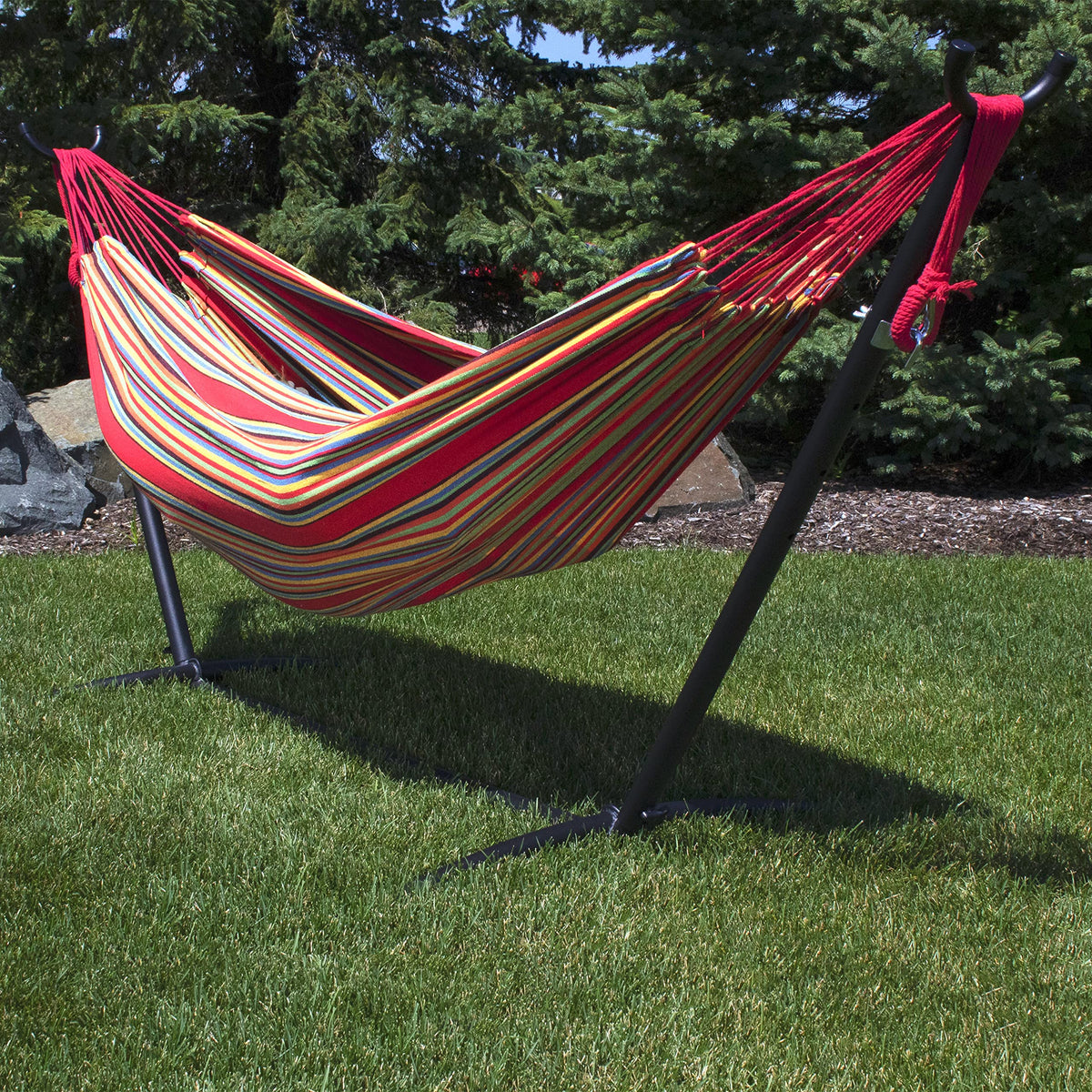 Sunnydaze double Brazilian cotton hammock sunset between trees setup enables easy backyard relaxation.