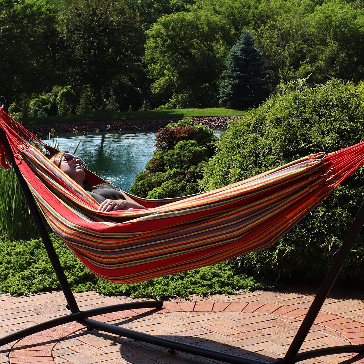 Sunnydaze double Brazilian cotton hammock sunset on stand demonstrates versatile outdoor lounging.