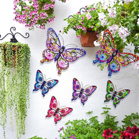 SUNREEK small pink butterfly wall decor complements garden borders.