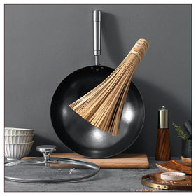 Sunrise Bamboo Wok Brush keeps hands away from heat during cleaning.