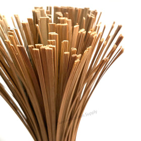Sunrise Bamboo Wok Brush used on a hot stove for quick cleanup.