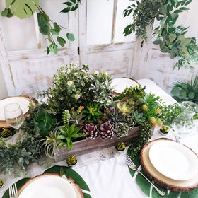 Supla wood planter box filled with succulents creates a natural, minimalist centerpiece.