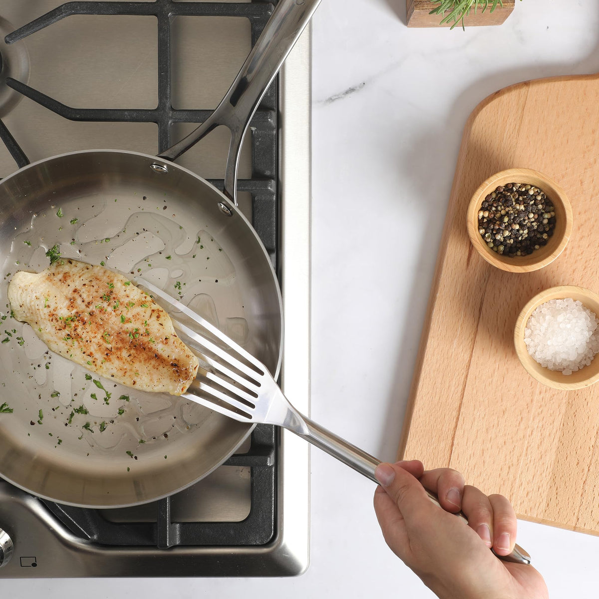 Sur La Table Steelhaus fish turner stored neatly in a kitchen drawer.