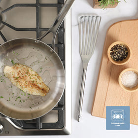 Sur La Table Steelhaus fish turner resting over pan for controlled flip.