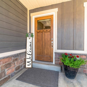 Surfapans front door decor in white wood complements exterior styles.