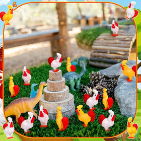 Suzile resin chick figurine in a small garden scene.