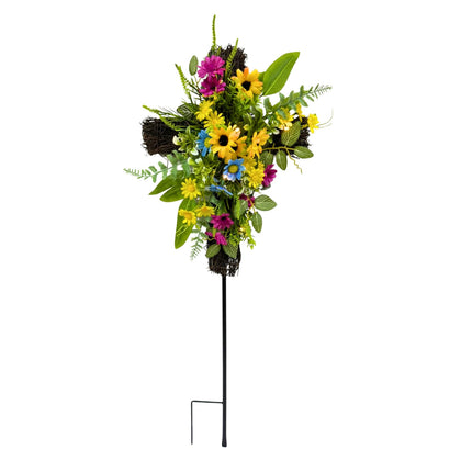 Svndlyn solar cross stake with sunflowers and daisies enhances a memorial garden at dusk