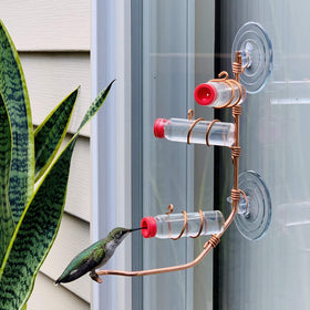 SWEET FEEDERS window feeder with glass bottles for easy refills.