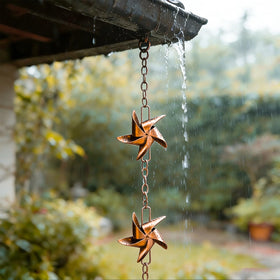 Taman rose gold rain chain decorates the exterior with practical water guidance.