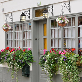 Tandefio black iron bracket mounted on wall, ideal for outdoor use and displays.