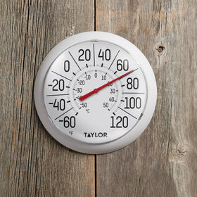 Taylor thermometer mounted on patio or garage wall for easy checks.