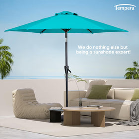 Tempera turquoise umbrella setup on a patio, ready for shade.