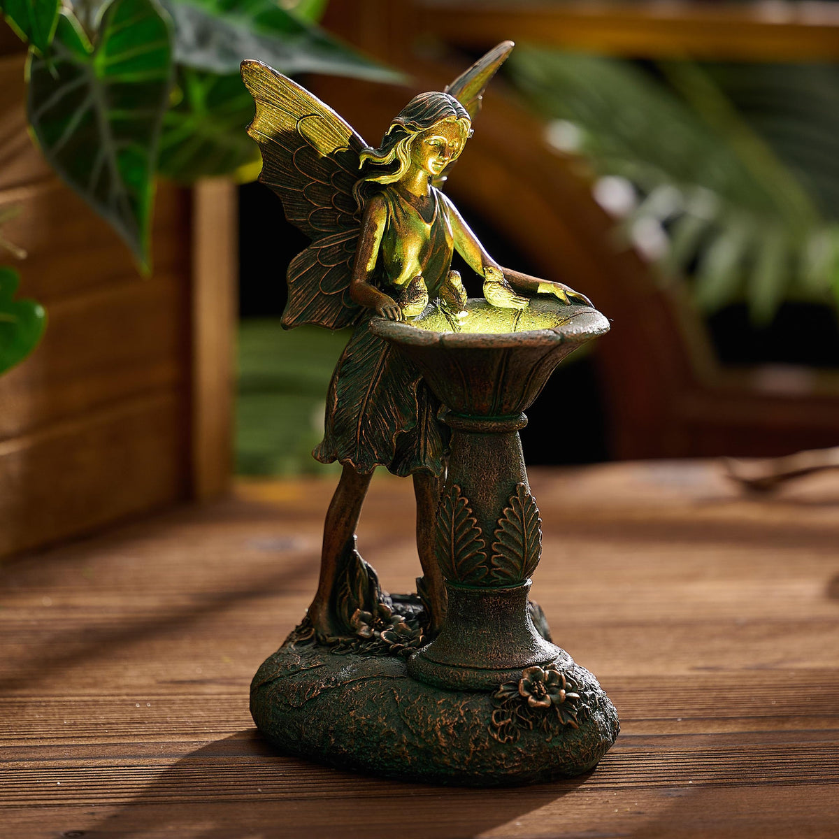 Bronze-tone fairy wing detail enhances yard decor with intricate resin craftsmanship.