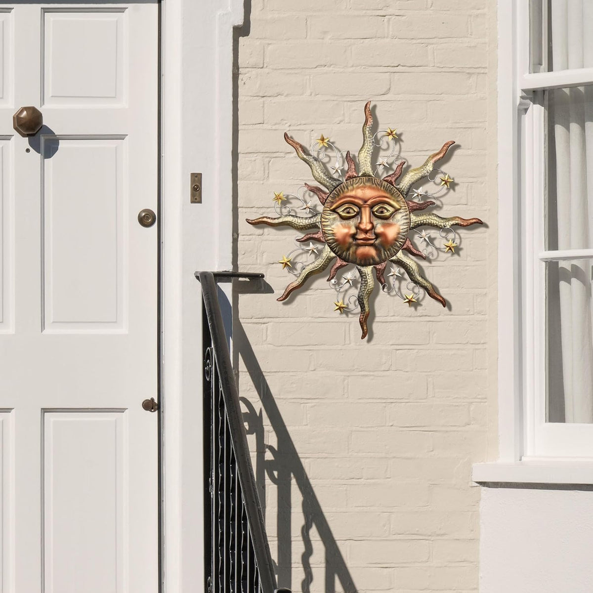 Teresa's sun face sculpture brightens a balcony with celestial artistry.