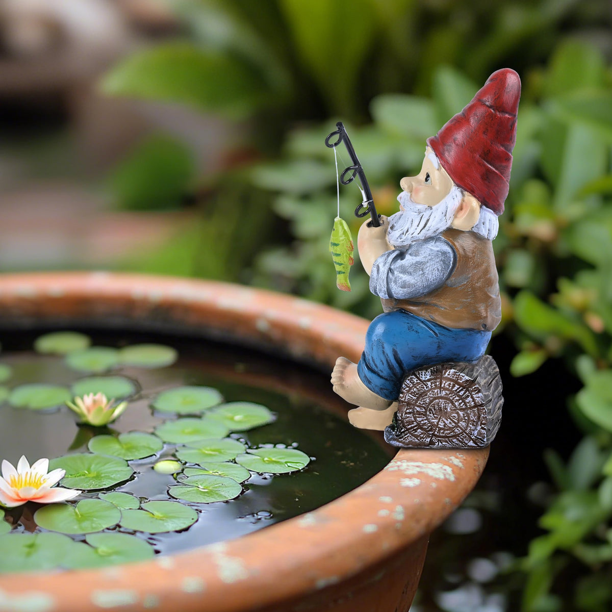 Teresa's Collections garden-edge scene gnome pairs with flowers for a whimsical focal point.
