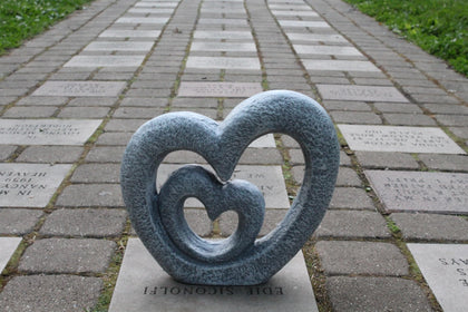 The Lakeside Collection Nesting Hearts Garden Sculpture in grey adds timeless outdoor romance and durable beauty.
