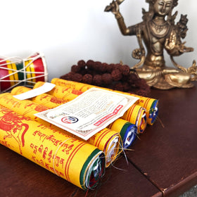 Indoor and outdoor display of prayer flags with world peace motifs by The Swayambhu.