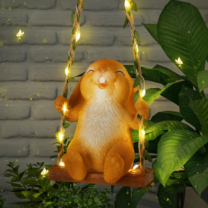 Thyle solar outdoor bunny on a swing glows softly at dusk for garden charm.