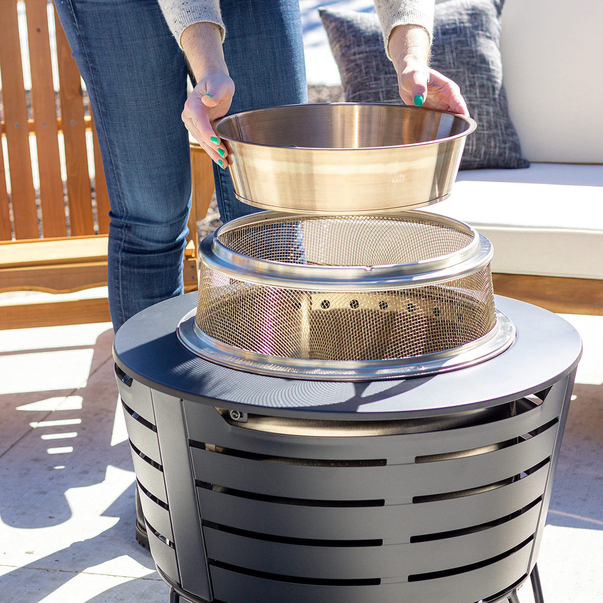 TIKI stainless steel heat deflector adds durable outdoor warmth.