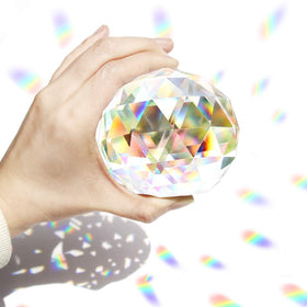 Tirifer clear crystal suncatcher 80mm with rainbow reflections on a window
