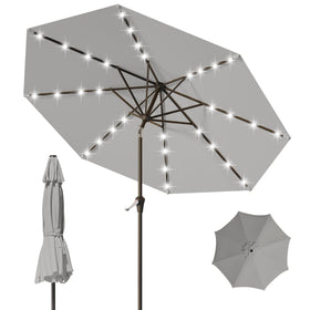Tobeos 9FT patio umbrella with solar LEDs lighting an outdoor table at dusk.