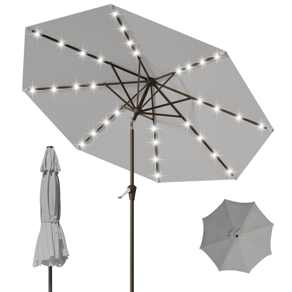 Tobeos 9FT patio umbrella with solar LEDs lighting an outdoor table at dusk.