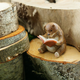 Top Collection baby bear reading statue close-up highlights craftsmanship.