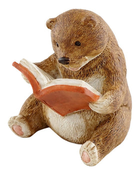 Top Collection baby bear reading statue in a fairy garden adds whimsy.