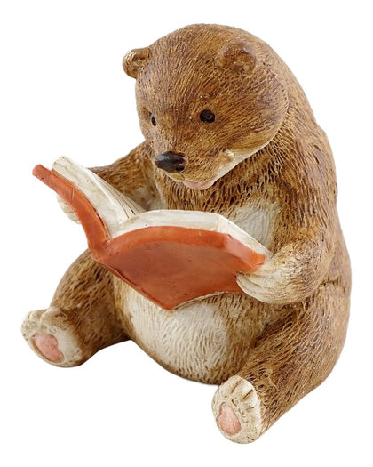 Top Collection baby bear reading statue in a fairy garden adds whimsy.