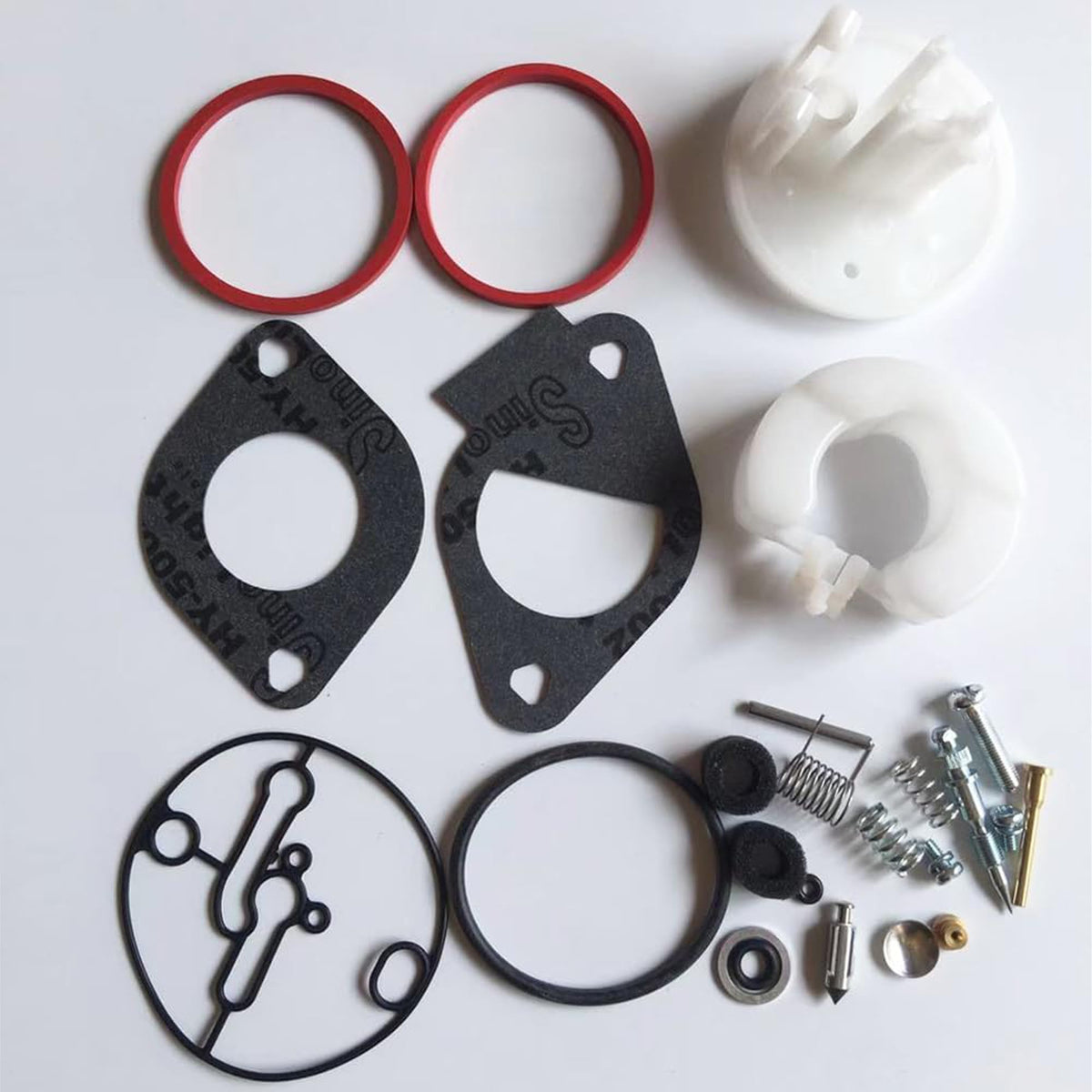 Closeup of Tormudaca carburetor kit components showing quality parts