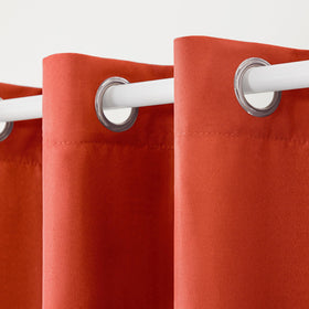 TOWN AND COUNTRY BASICS Cabana heavyweight curtains Mecca Orange provide outdoor light filtering.
