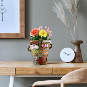 TOZLU Picasso brutalist face pot stands out with sculptural appeal outdoors.
